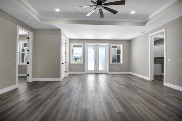 unfurnished living room with french doors, a raised ceiling, dark wood finished floors, and baseboards