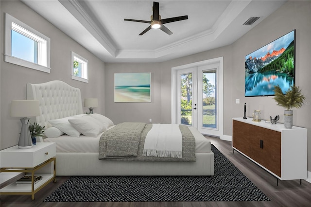 bedroom with visible vents, a raised ceiling, dark wood-style flooring, access to outside, and french doors