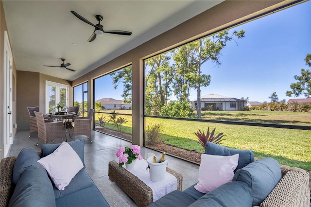 sunroom featuring ceiling fan