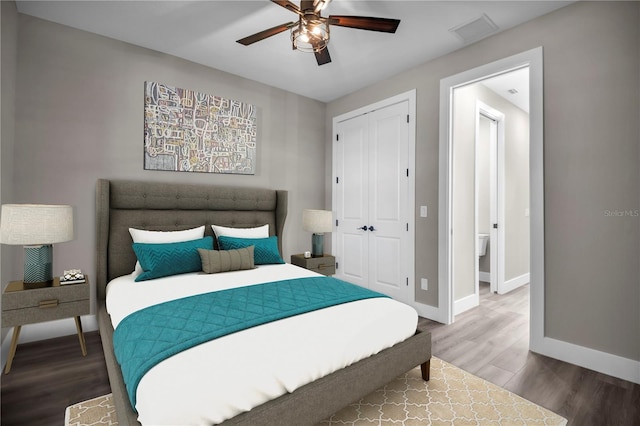 bedroom with a closet, visible vents, a ceiling fan, wood finished floors, and baseboards