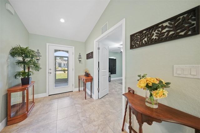 entryway with lofted ceiling, ceiling fan, and light tile patterned floors