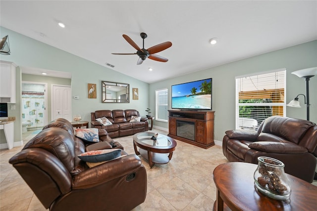 living room with lofted ceiling, ceiling fan, and light tile patterned floors