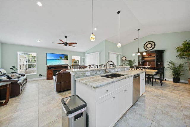 kitchen with light stone counters, dishwasher, an island with sink, white cabinets, and sink