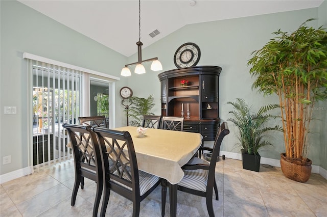 tiled dining area with lofted ceiling