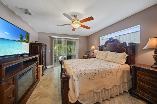 tiled bedroom with ceiling fan and access to outside