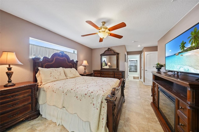 tiled bedroom featuring ensuite bath, ceiling fan, and multiple windows