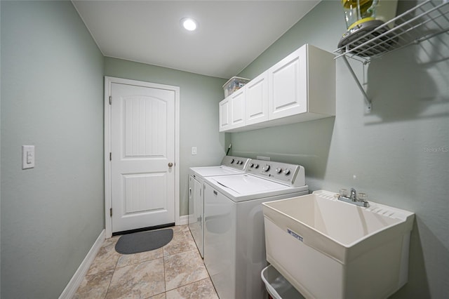 clothes washing area featuring cabinets, separate washer and dryer, and sink