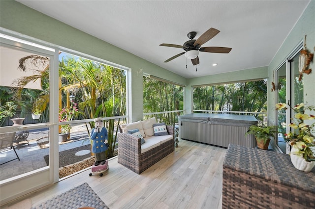 sunroom / solarium with a hot tub and ceiling fan