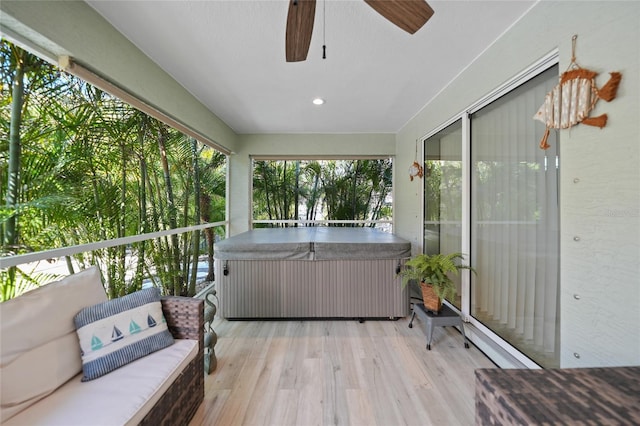 exterior space featuring ceiling fan, a hot tub, and outdoor lounge area