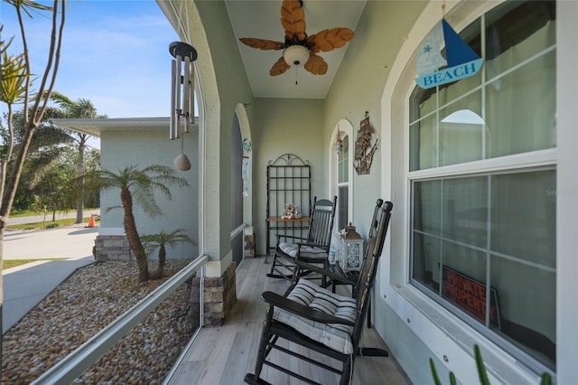 balcony with covered porch and ceiling fan