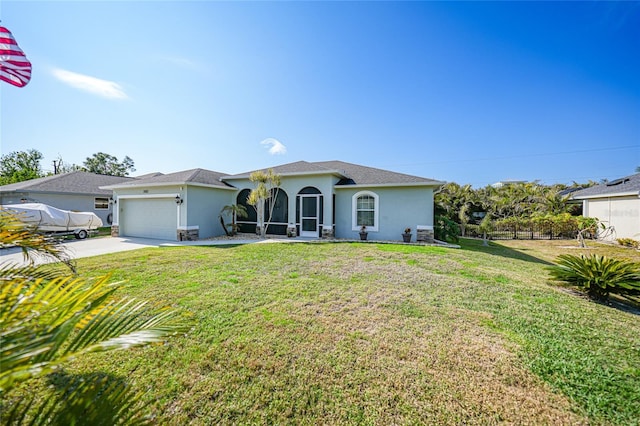 view of front of property with a front lawn and a garage