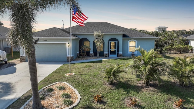 view of front of home featuring a yard and a garage