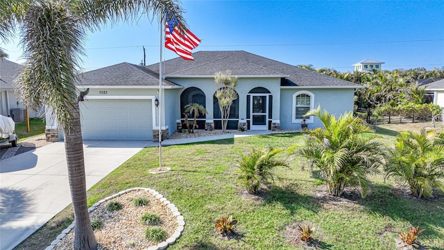 view of front facade with a garage and a front lawn