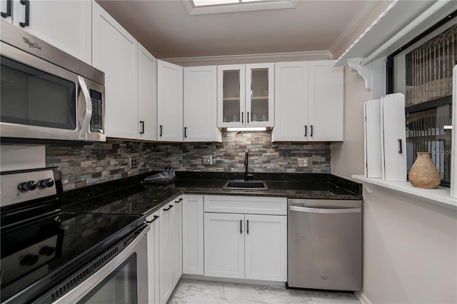 kitchen featuring sink, white cabinets, stainless steel appliances, and dark stone counters