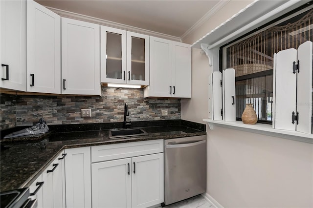 kitchen with stainless steel dishwasher, white cabinets, sink, and dark stone countertops