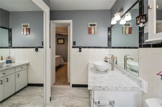 bathroom with tile walls and vanity