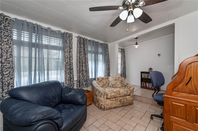 tiled living room featuring ceiling fan and crown molding