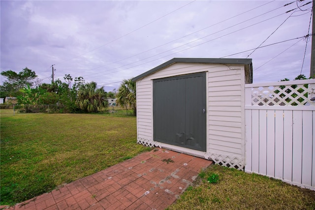 view of outbuilding featuring a lawn