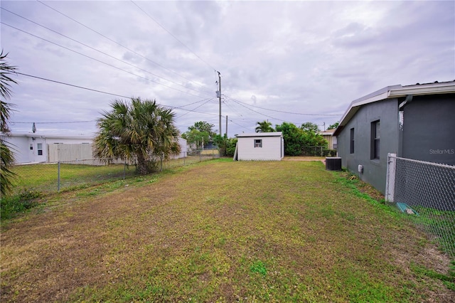 view of yard with a shed and cooling unit