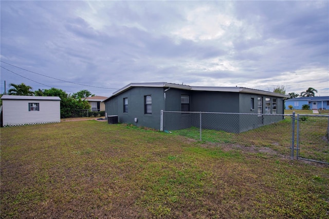 exterior space featuring a lawn and a storage unit