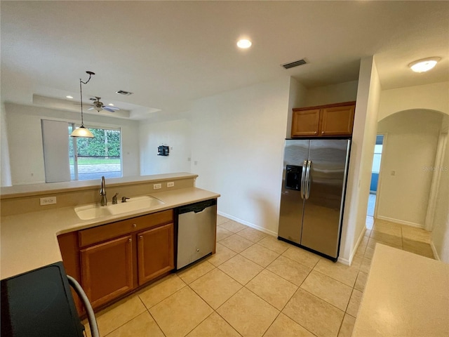 kitchen with stainless steel appliances, light tile patterned flooring, sink, and pendant lighting