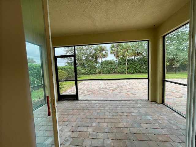 unfurnished sunroom with plenty of natural light