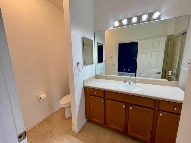 bathroom featuring tile patterned floors, toilet, an enclosed shower, and vanity