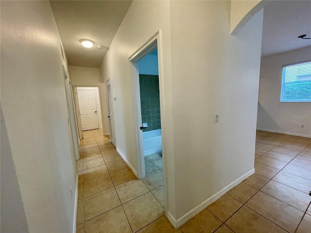 hall with light tile patterned flooring