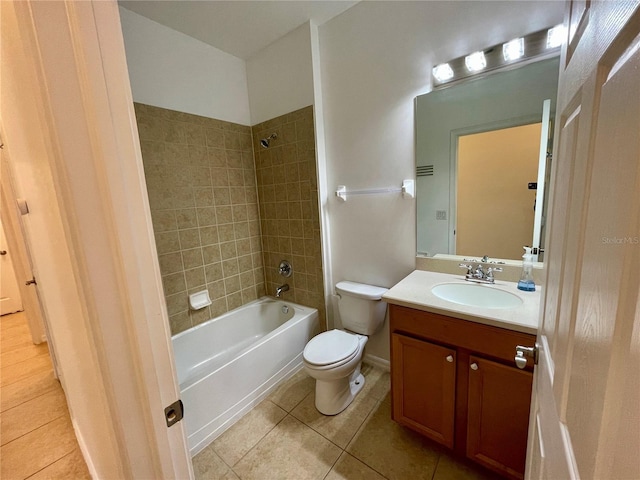 full bathroom with tiled shower / bath, vanity, toilet, and tile patterned flooring