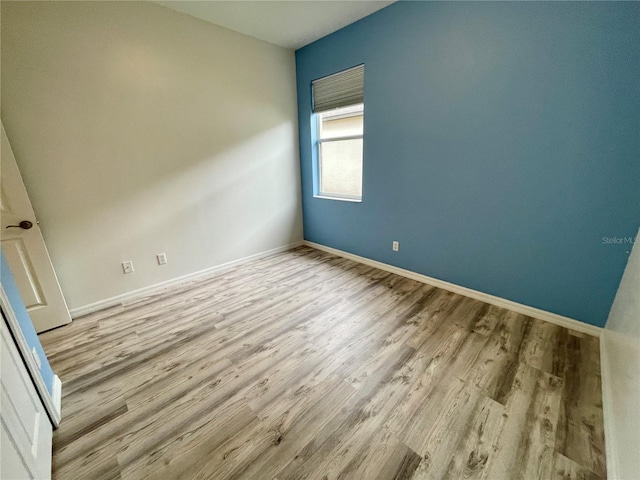 spare room with light hardwood / wood-style flooring