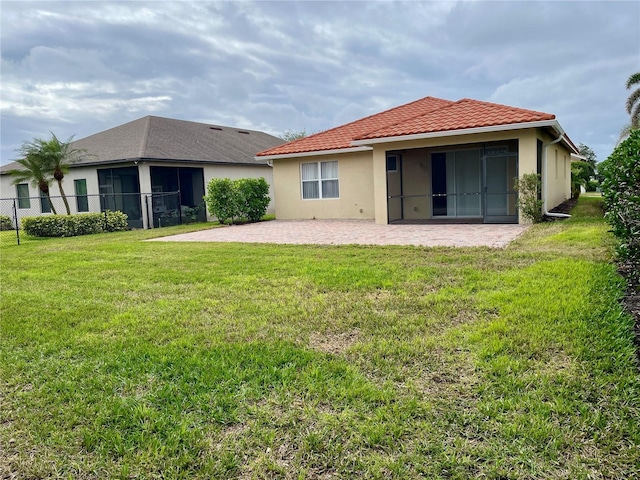 back of house featuring a yard and a patio area