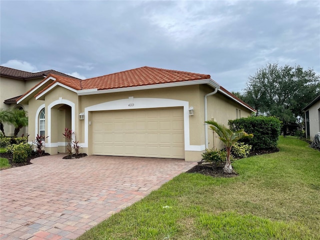 view of front of home with a garage and a front lawn