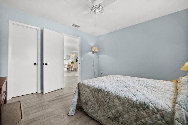 bedroom featuring ceiling fan and light hardwood / wood-style floors