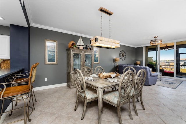 dining area featuring light tile patterned floors, baseboards, and crown molding