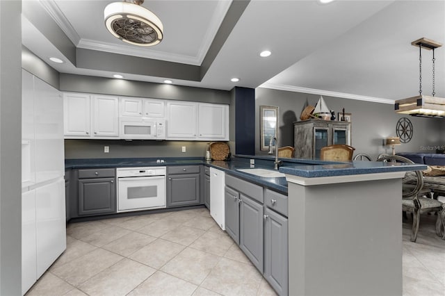 kitchen with white appliances, white cabinets, dark countertops, gray cabinets, and a sink