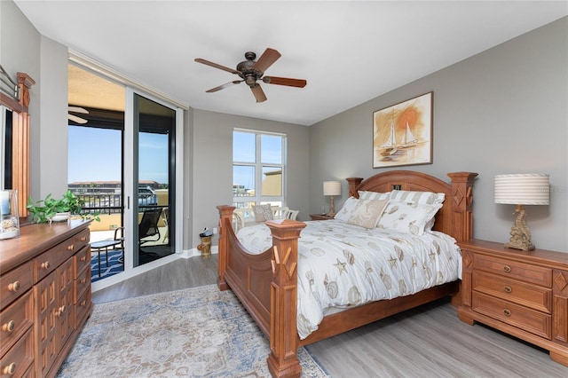 bedroom featuring access to exterior, light wood-style flooring, and ceiling fan