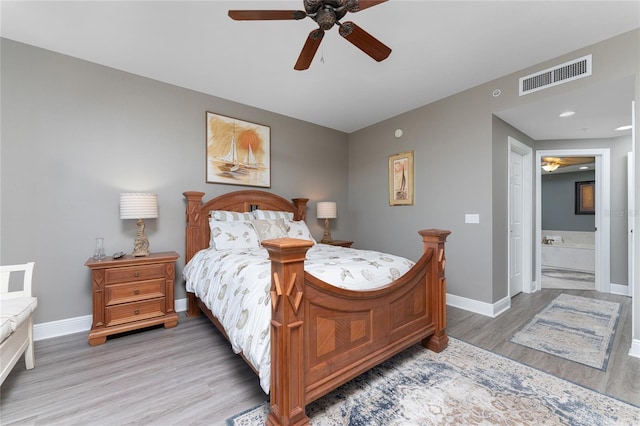 bedroom featuring visible vents, light wood-style flooring, a ceiling fan, connected bathroom, and baseboards