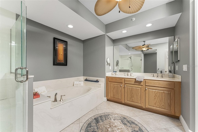 full bath featuring double vanity, a garden tub, a sink, and tile patterned floors