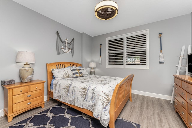 bedroom with light wood-style floors and baseboards