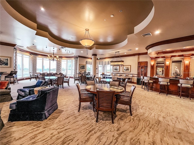 dining room with light carpet, visible vents, ornamental molding, a tray ceiling, and recessed lighting