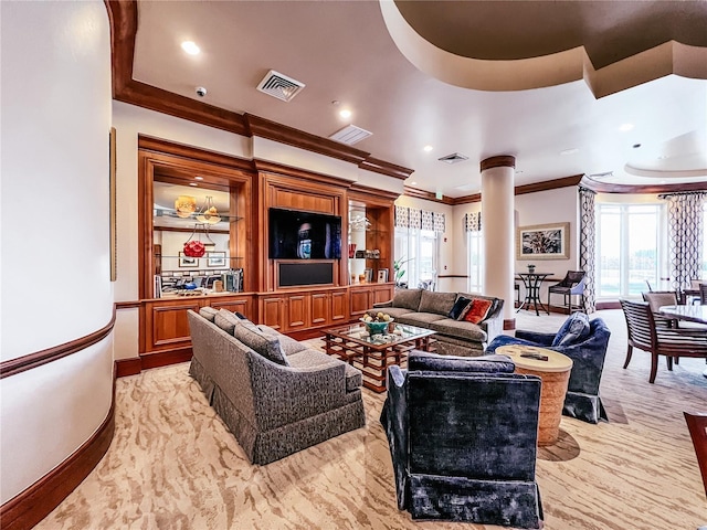 living room with crown molding, visible vents, and ornate columns