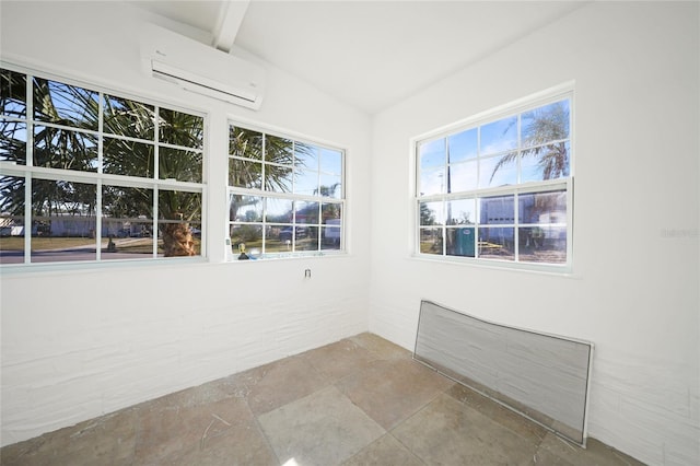 unfurnished sunroom with beam ceiling and a wall mounted AC