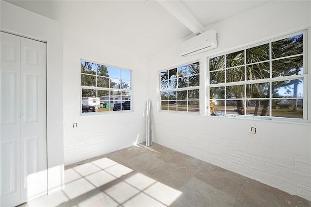 unfurnished sunroom featuring a wall mounted AC and beamed ceiling