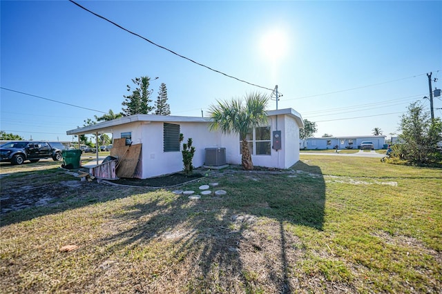 exterior space featuring cooling unit and a yard