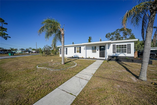 ranch-style house featuring a front lawn