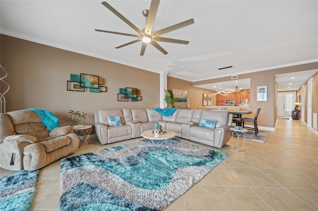 living room with ceiling fan, light tile patterned floors, and crown molding