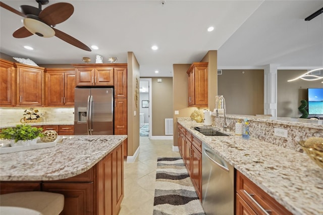 kitchen with ceiling fan, sink, pendant lighting, light tile patterned floors, and appliances with stainless steel finishes