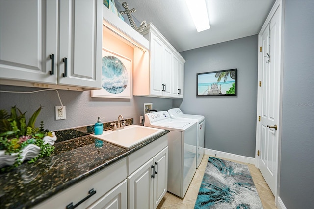 laundry room featuring washing machine and dryer, sink, light tile patterned floors, and cabinets