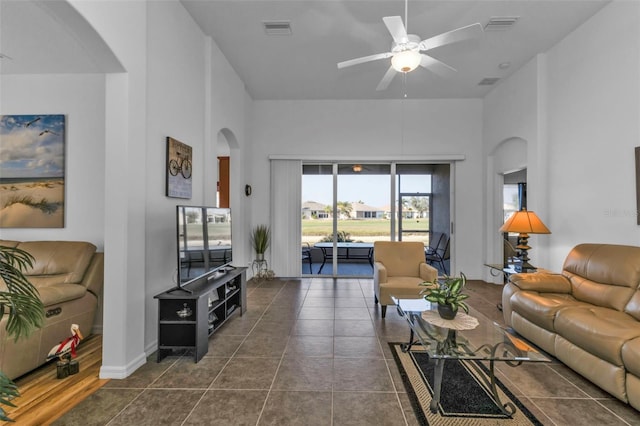 tiled living room featuring ceiling fan