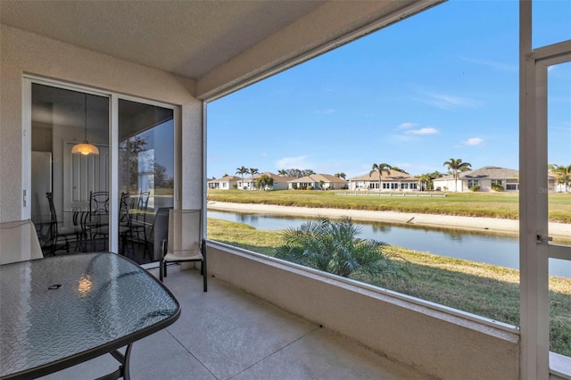 sunroom / solarium with a healthy amount of sunlight and a water view